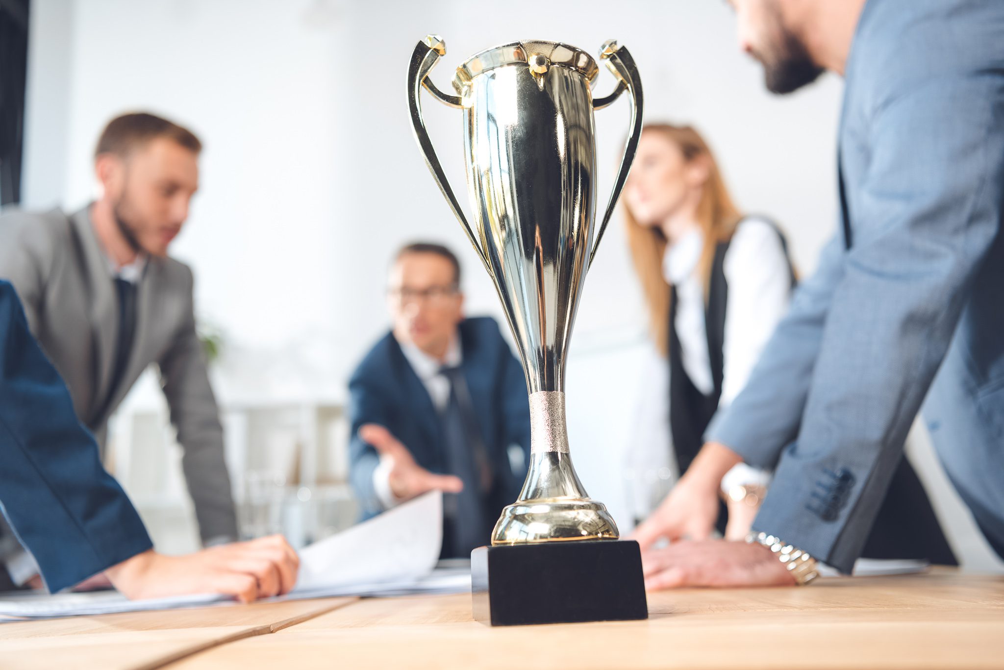 champion cup standing on table at conference hall in office